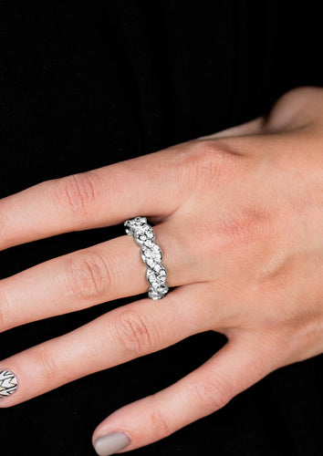 Encrusted in dainty white rhinestones, glistening silver bars braid across the finger for a refined look. Features a dainty stretchy band for a flexible fit.  Sold as one individual ring.