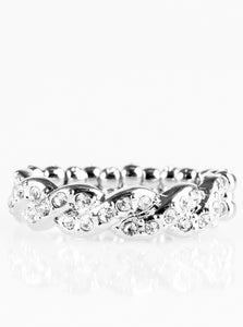 Encrusted in dainty white rhinestones, glistening silver bars braid across the finger for a refined look. Features a dainty stretchy band for a flexible fit.  Sold as one individual ring.