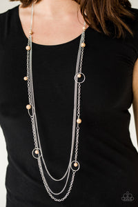   Infused with two plain strands of shimmery silver chains, polished brown beads and shimmery silver hoops trickle along a bold silver chain for a whimsically layered look. Features an adjustable clasp closure.  Sold as one individual necklace. Includes one pair of matching earrings. Always nickel and lead free.