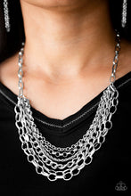 Load image into Gallery viewer, Mismatched silver chains layer below the collar for a bold industrial look. Painted in a neutral finish, a shiny gray chain drapes between the shimmery silver chains for a vivacious finish. Features an adjustable clasp closure.  Sold as one individual necklace. Includes one pair of matching earrings.  Always nickel and lead free.