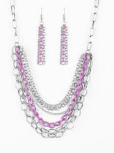 Load image into Gallery viewer, Mismatched silver chains layer below the collar for a bold industrial look. Painted in a colorful finish, a shiny purple chain drapes between the shimmery silver chains for a vivacious finish. Features an adjustable clasp closure.  Sold as one individual necklace. Includes one pair of matching earrings.