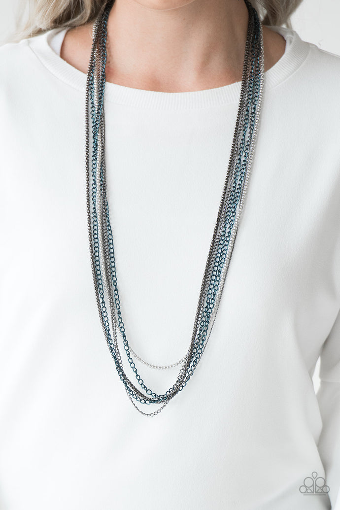 Brushed in a metallic finish, blue chains collide with mismatched gunmetal and silver chains across the chest. Shimmery silver and gunmetal popcorn chains join the colorful layers, adding shimmery metallic texture to the spunky mixed palette. Features an adjustable clasp closure.  Sold as one individual necklace. Includes one pair of matching earrings.  Always nickel and lead free.