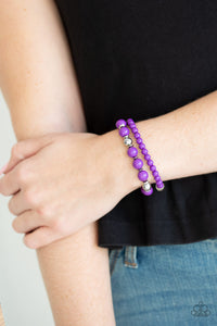 A collection of polished purple, shiny silver, and faceted crystal-like beads are threaded along stretchy bands around the wrist for a colorfully layered look.  Sold as one set of two bracelets.  Always nickel and lead free.