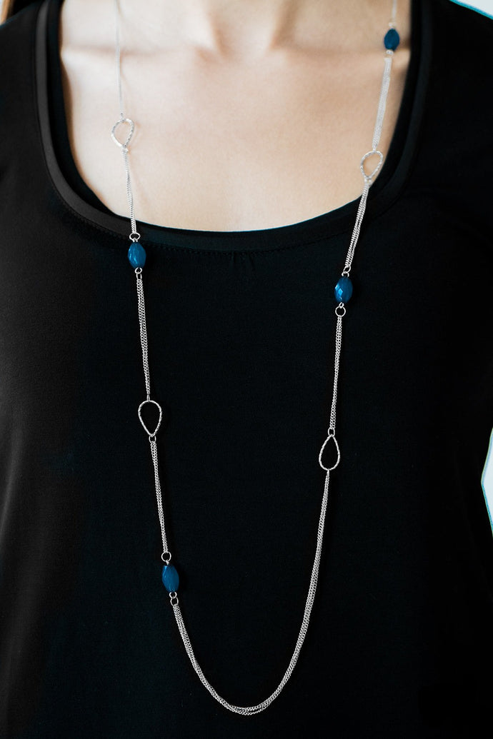 Faceted blue beads join shimmery silver teardrop frames along glistening silver chain for a colorfully casual look. Features an adjustable clasp closure.  Sold as one individual necklace. Includes one pair of matching earrings.