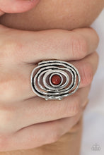 Load image into Gallery viewer, A robust Chili Oil bead dots the center of delicately hammered silver bars rippling into a dizzying frame atop the finger. Features a stretchy band for a flexible fit.   Sold as one individual ring.   Always nickel and lead free!