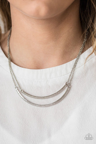 Two shiny silver frames bow below the collar, creating glistening layers. The bottom of the bowing frames are etched in serrated textures for a radiant finish. Features an adjustable clasp closure.  Sold as one individual necklace. Includes one pair of matching earrings.  Always nickel and lead free.