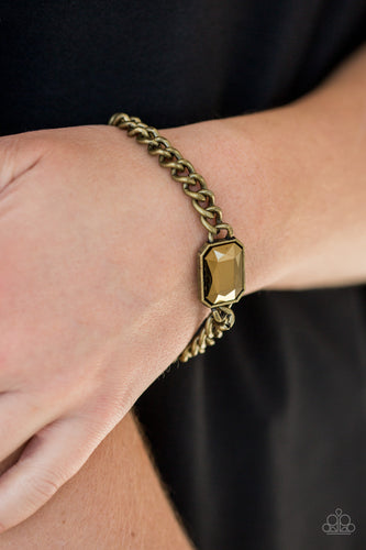 Featuring an edgy emerald-style cut, a glittery aurum gem attaches to a bold brass chain, creating a dramatic centerpiece atop the wrist. Features an adjustable clasp closure.  Sold as one individual bracelet.  Always nickel and lead free.
