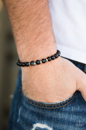 Glassy black beads are threaded along a stretchy elastic band for a seasonal look. Infused with silver accents, the shiny black beads are brushed in a metallic marble finish for an earthy finish.  Sold as one individual bracelet.  Always nickel and lead free.