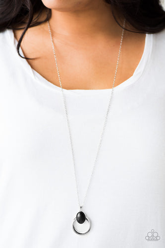 A smooth black stone is pressed into a circular silver pendant for a handcrafted, artisan inspired look. Features an adjustable clasp closure.  Sold as one individual necklace. Includes one pair of matching earrings.  Always nickel and lead free.