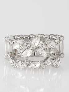 Featuring round and regal marquise style cuts, glittery white rhinestones stack across the finger in two glittery bands. Features a stretchy band for a flexible fit.  Sold as one individual ring.