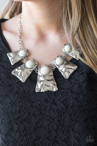 Rippling with hammered details, flared silver frames join below the collar, creating a fierce fringe. Refreshing white stones are pressed into the tops of the frames for a colorful finish. Features an adjustable clasp closure.  Sold as one individual necklace. Includes one pair of matching earrings. Always nickel and lead free.