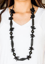 Load image into Gallery viewer, Featuring round, faceted, and distressed finishes, mismatched black wooden beads are threaded along shiny black cording for a summery look. Features an adjustable sliding knot closure.   Sold as one individual necklace. Includes one pair of matching earrings.  Always nickel and lead free.