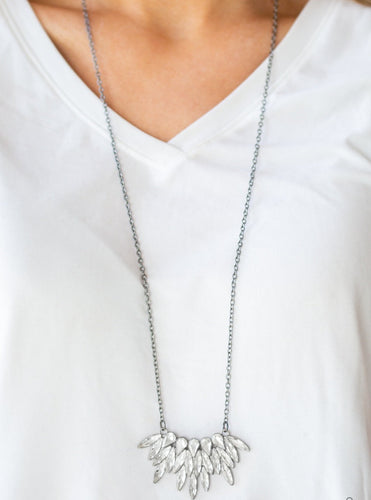 Featuring regal teardrop and marquise style cuts, glittery white rhinestones fan from the bottom of a lengthened gunmetal chain for a dramatic look. Features an adjustable clasp closure.  Sold as one individual necklace. Includes one pair of matching earrings.  