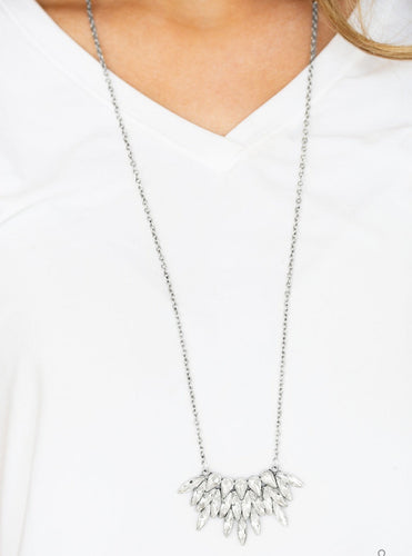 Featuring regal teardrop and marquise style cuts, glittery white rhinestones fan from the bottom of a lengthened silver chain for a dramatic look. Features an adjustable clasp closure.  Sold as one individual necklace. Includes one pair of matching earrings. 