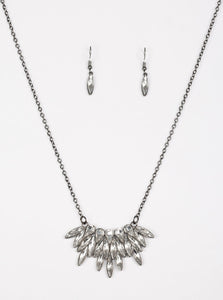 Featuring regal teardrop and marquise style cuts, glittery white rhinestones fan from the bottom of a lengthened gunmetal chain for a dramatic look. Features an adjustable clasp closure.  Sold as one individual necklace. Includes one pair of matching earrings.