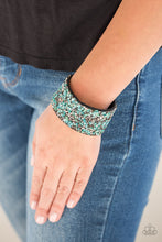 Load image into Gallery viewer, Smoky and hematite prism style rhinestones and bits of crushed green rock are sprinkled across a thick black suede band for an edgy look. Features an adjustable snap closure.  Sold as one individual bracelet.  Always nickel and lead free.