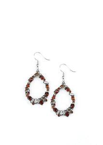 Featuring classic round and edgy emerald style cuts, glassy red, white, and topaz rhinestones are encrusted along a silver teardrop frame for a sassy look. Earring attaches to a standard fishhook fitting. Sold as one pair of earrings.