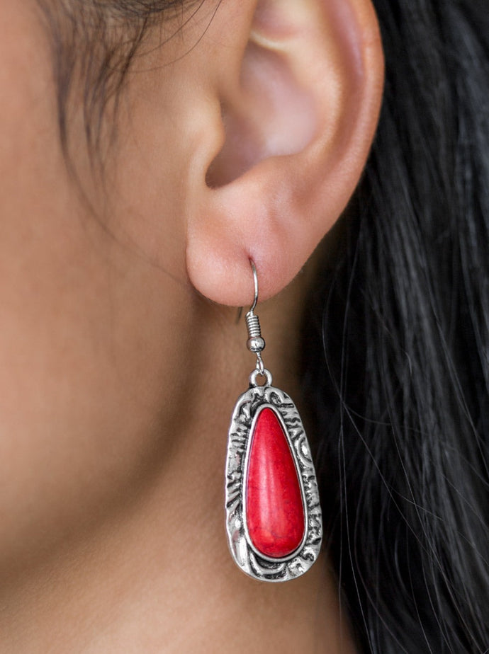 Chiseled into a tranquil teardrop, a fiery red stone is pressed into the center of a shimmery silver frame radiating with hammered details for an artisan inspired look. Earring attaches to a standard fishhook fitting.  Sold as one pair of earrings.