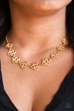 Load image into Gallery viewer, Necklace - Ribbons of dotted gold twist into knotted metallic frames, creating an elegant look below the collar. Features an adjustable clasp closure.  Bracelet - Ribbons of dotted gold twist into knotted metallic frames, creating an elegant look around the wrist. Features an adjustable clasp closure.