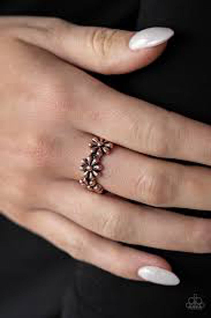 A row of dainty copper daisies connect across the finger, coalescing into a whimsical band. Features a dainty stretchy band for a flexible fit.  Sold as one individual ring.   Always nickel and lead free.
