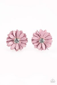 Layers of purple suede petals stack into a pair of billowy blossoms. Glassy white rhinestones adorn the centers, adding refined shimmer to the spring inspired flowers. Each flower features a standard hair clip on the back.  Sold as one pair of hair clips.   Always nickel and lead free. 