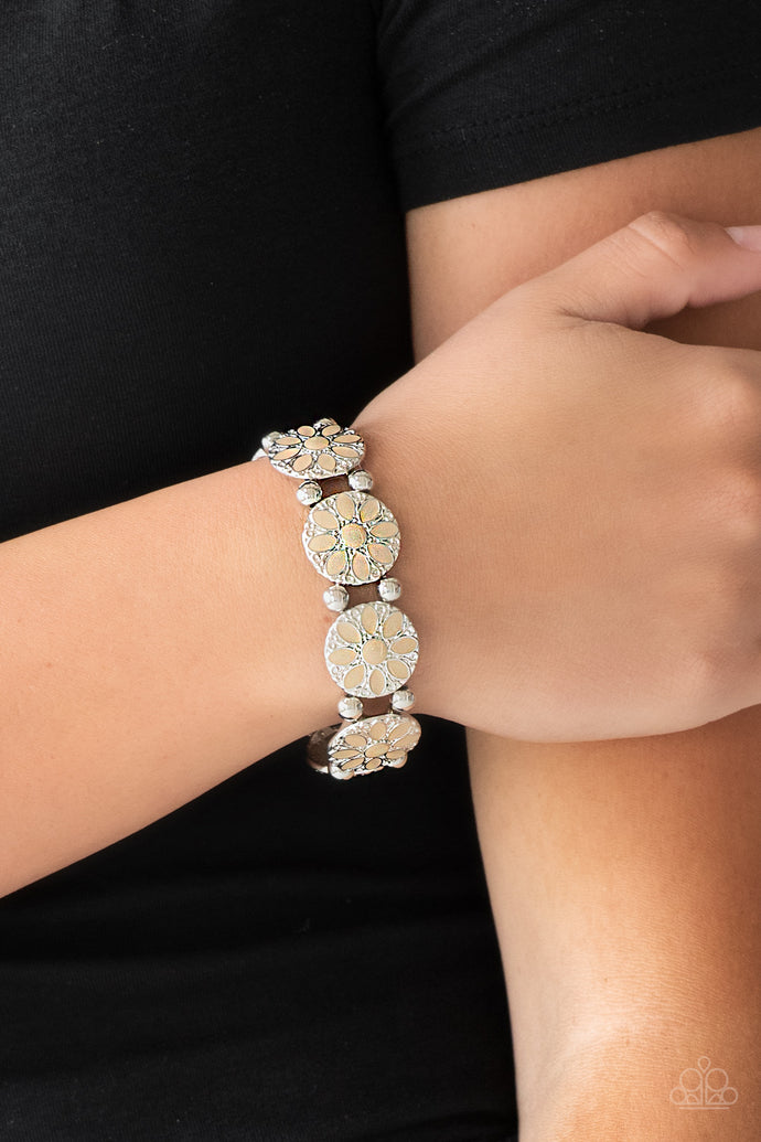 Painted in a neutral brown finish, ornate silver floral frames are threaded along a stretchy band across the wrist for a seasonal look.  Sold as one individual bracelet.  Always nickel and lead free.