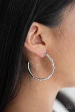 Load image into Gallery viewer, Brushed in a high-sheen finish, a jagged silver hoop curls around the ear for an edgy look. Earring attaches to a standard post fitting. Hoop measures 1 1/2&quot; in diameter.  Sold as one pair of hoop earrings. Always nickel and lead free.