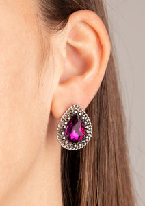 A glittery pink teardrop gem is pressed into the center of a silver frame radiating with glittery hematite rhinestones. A chain of shimmery silver links border the sparkling center for an edgy elegance. Earring attaches to a standard post fitting.  Sold as one pair of post earrings.