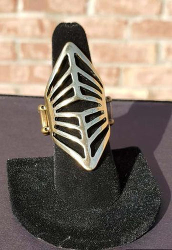 A glistening diamond-shaped brass frame in an art deco pattern folds around the finger for an edgy, geometric look. Features a stretchy band for a flexible fit.  Sold as one individual ring. 