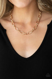 Pairs of joined gold links connect a collection of gold oval frames below the collar, creating an edgy chain. Features an adjustable clasp closure.  Sold as one individual necklace. Includes one pair of matching earrings.  Always nickel and lead free.  Fashion Fix Exclusive June 2021 