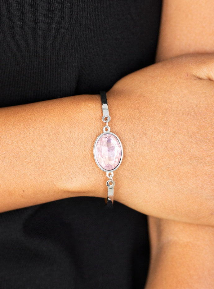 Arcing silver bars connect to a faceted pink gem centerpiece, creating a dainty cuff-like bracelet around the wrist. Features an adjustable clasp closure.  Sold as one individual bracelet. 