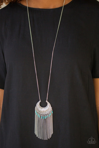Etched in geometric patterns, a silver crescent swings from the bottom of an elongated silver chain. The tribal inspired pendant gives way to a shimmery fringe sprinkled with shiny blue beads for a seasonal finish. Features an adjustable clasp closure.  Sold as one individual necklace. Includes one pair of matching earrings.
