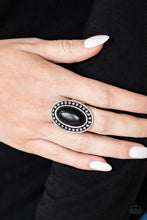 Load image into Gallery viewer, Chiseled into a smooth oval, an earthy black stone is pressed into a studded silver frame for a seasonal flair. Features a stretchy band for a flexible fit.  Sold as one individual ring.  Always nickel and lead free.