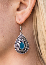 Load image into Gallery viewer, Painted in a blue center, an ornate teardrop embossed in tribal inspired textures swings from the ear in an indigenous fashion. Earring attaches to a standard fishhook fitting.  Sold as one pair of earrings.
