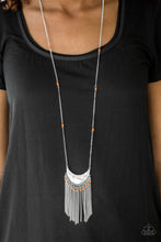 Load image into Gallery viewer, A delicately hammered silver crescent swings from the bottom of an elongated silver chain infused with orange seed bead accents. The tribal inspired pendant gives way to a shimmery fringe sprinkled with more seed beads for a wanderlust finish. Features an adjustable clasp closure.  Sold as one individual necklace. Include one pair of matching earrings.  Always nickel and lead free.