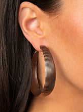 Load image into Gallery viewer, Lined in antiqued ridges, a thick copper hoop curls around the ear for an authentically rustic look. Earring attaches to a standard post fitting. Hoop measures approximately 2 ¼” in diameter.  Sold as one pair of hoop earrings.