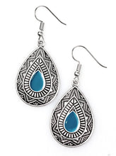 Load image into Gallery viewer, Painted in a blue center, an ornate teardrop embossed in tribal inspired textures swings from the ear in an indigenous fashion. Earring attaches to a standard fishhook fitting.  Sold as one pair of earrings.