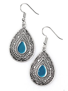 Painted in a blue center, an ornate teardrop embossed in tribal inspired textures swings from the ear in an indigenous fashion. Earring attaches to a standard fishhook fitting.  Sold as one pair of earrings.