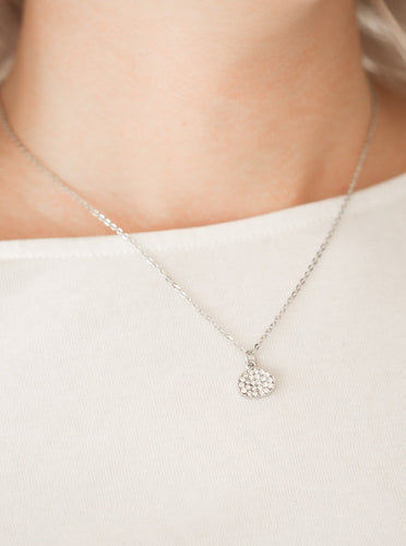 Encrusted in glassy white rhinestones, an asymmetrical silver frame swings from the bottom of a shimmery silver chain for a timeless look. Features an adjustable clasp closure.  Sold as one individual necklace. Includes one pair of matching earrings.