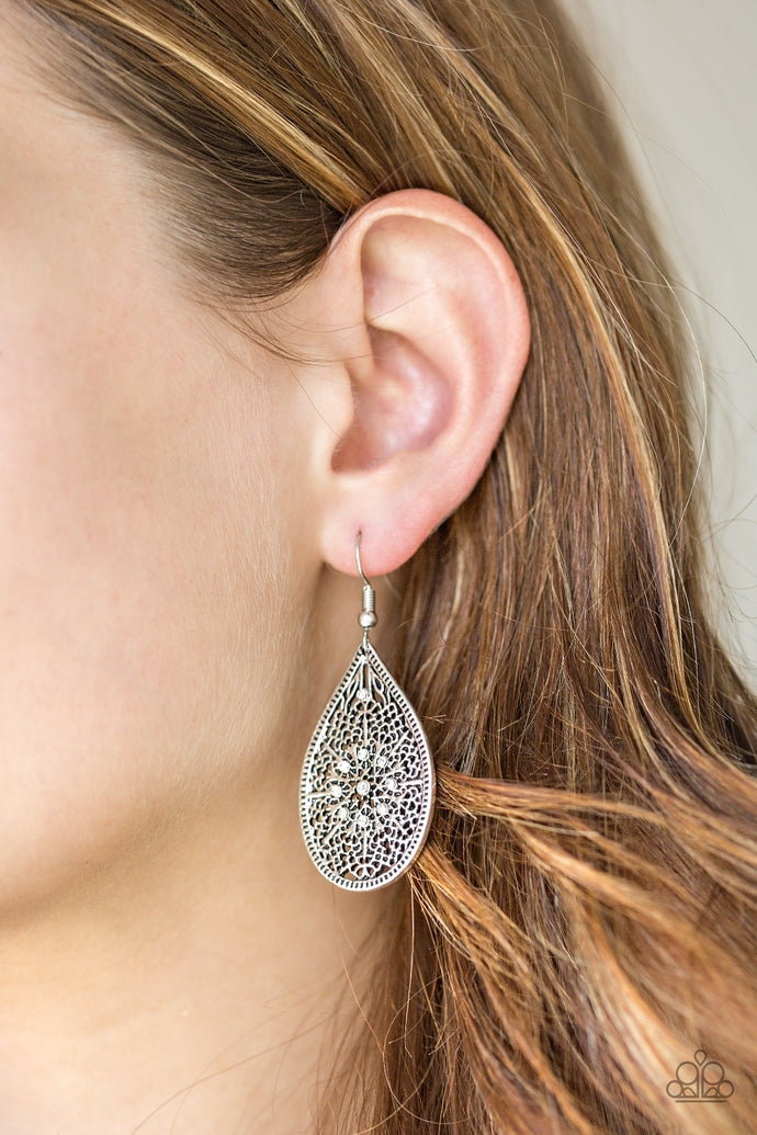 Featuring an elegant filigree filled backdrop, a shimmery silver teardrop swings from the ear. Dainty white rhinestones are sprinkled across the frame for a glamorous finish. Earring attaches to a standard fishhook fitting.  Sold as one pair of earrings.  Always nickel and lead free.