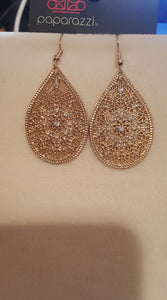 Featuring an elegant filigree filled backdrop, a shimmery gold teardrop swings from the ear. Dainty white rhinestones are sprinkled across the frame for a glamorous finish. Earring attaches to a standard fishhook fitting.  Sold as one pair of earrings.   Always nickel and lead free.