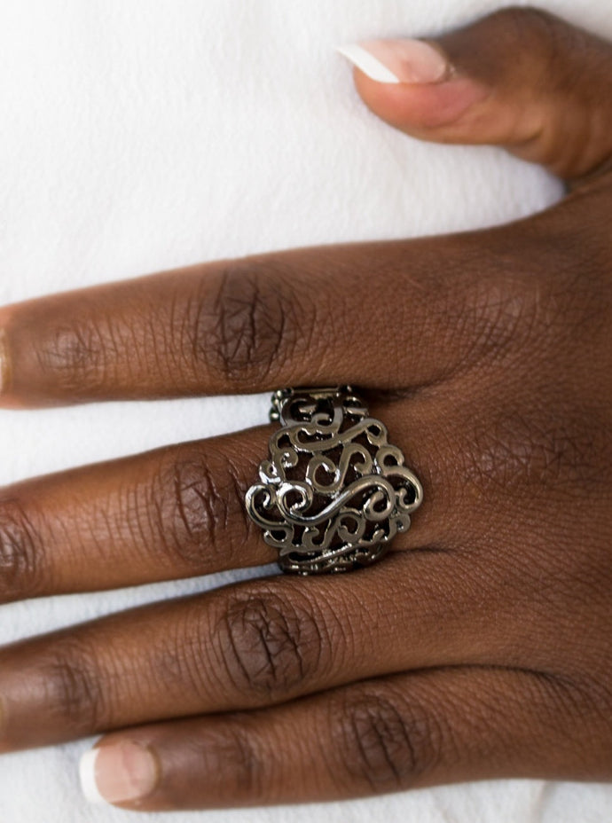 Glistening gunmetal filigree swirls across the finger for a seasonal look. Features a stretchy band for a flexible fit.  Sold as one individual ring.