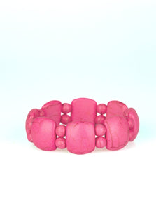 A collection of round and square-like pink stones are threaded along stretchy bands around the wrist for a seasonal look.  Sold as one individual bracelet.