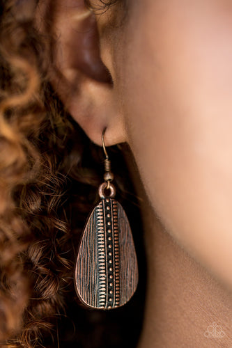 Scratched in linear texture, an asymmetrical copper frame swings from the ear. Tribal inspired patterns are embossed down the center of the lure for a tactile finish. Earring attaches to a standard fishhook fitting.  Sold as one pair of earrings.  Always nickel and lead free.