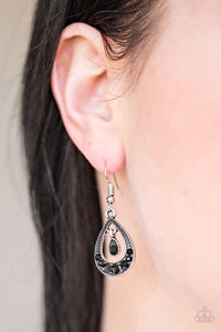 As if dipped in glitter, sparkling black rhinestones are encrusted along the bottom of a shimmery teardrop frame. A solitaire rhinestone swings from the top of the frame, creating a refined lure. Earring attaches to a standard fishhook fitting.  Sold as one pair of earrings.   Always nickel and lead free.