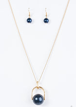 Load image into Gallery viewer, Brushed in a pearlescent shimmer, an oversized blue bead is pinched between a glistening gold frame, creating the illusion of a floating pearl for a dramatic look. Features an adjustable clasp closure.  Sold as one individual necklace. Includes one pair of matching earrings.