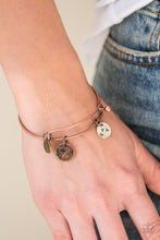 Load image into Gallery viewer, Stamped in dandelion patterns, glistening brass, copper, and silver charms featuring floral patterns slide along a sleek copper bar fitting for a whimsical look. Features a toggle closure.  Sold as one individual bracelet.  Always nickel and lead free.