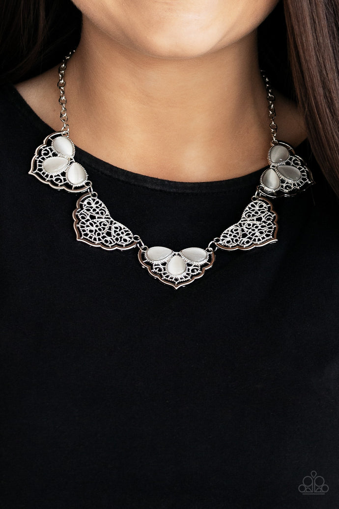 Filled with lacy-like patterns, filigree filled silver frames connect below the collar. Glowing white teardrop moonstones alternate along the airy frames, adding a refreshing hint of color to the whimsical fringe. Features an adjustable clasp closure.  Sold as one individual necklace. Includes one pair of matching earrings. Always nickel and lead free.