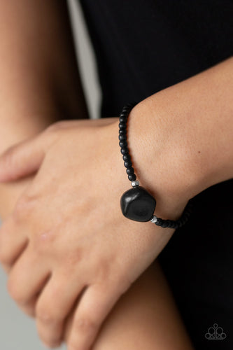 Infused with dainty silver beads and earthy black stone beads, a large black pebble is threaded along a stretchy band around the wrist for a seasonal flair.  Sold as one individual bracelet.  Always nickel and lead free.