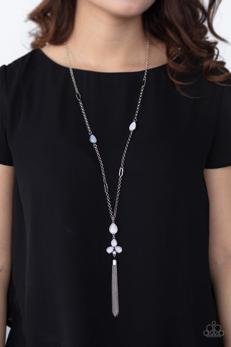 A cluster of dewy white teardrop beads coalesces at the bottom of a lengthened silver chain. Matching beads embedded in airy silver frames dot the chains that climb the chest, bringing an extra pop of color to the whimsical design. A glistening silver tassel cascades from the bottom of the colorful pendant, creating ethereal movement. Features an adjustable clasp closure.  Sold as one individual necklace. Includes one pair of matching earrings.  Always nickel and lead free.